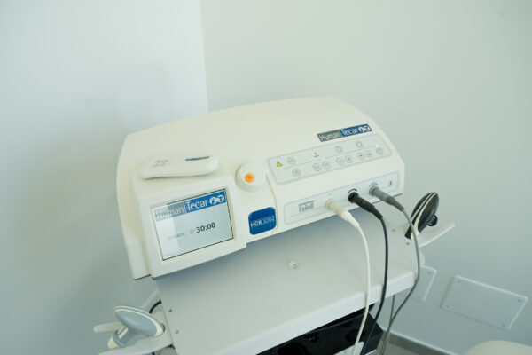 Electromagnetic therapy of the back, physiotherapist doctor uses medical equipment. Electromagnetic therapy of the back, physiotherapist doctor uses medical equipment for highly effective pain treatment and inflammation back, the magnetic field, rehabilitation.