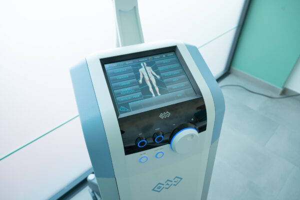 Electromagnetic therapy of the back, physiotherapist doctor uses medical equipment. Electromagnetic therapy of the back, physiotherapist doctor uses medical equipment for highly effective pain treatment and inflammation back, the magnetic field, rehabilitation.