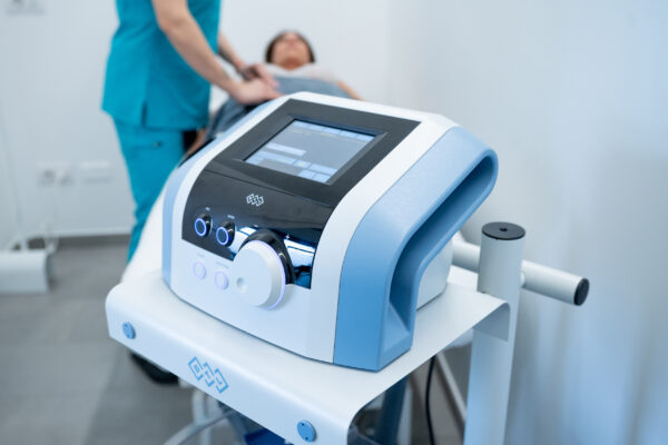 Electromagnetic therapy of the back, physiotherapist doctor uses medical equipment. Electromagnetic therapy of the back, physiotherapist doctor uses medical equipment for highly effective pain treatment and inflammation back, the magnetic field, rehabilitation.